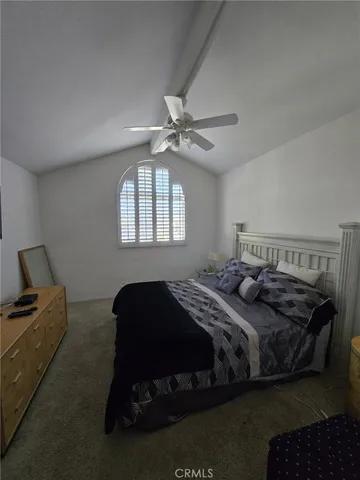 a bedroom with a bed dresser and a window