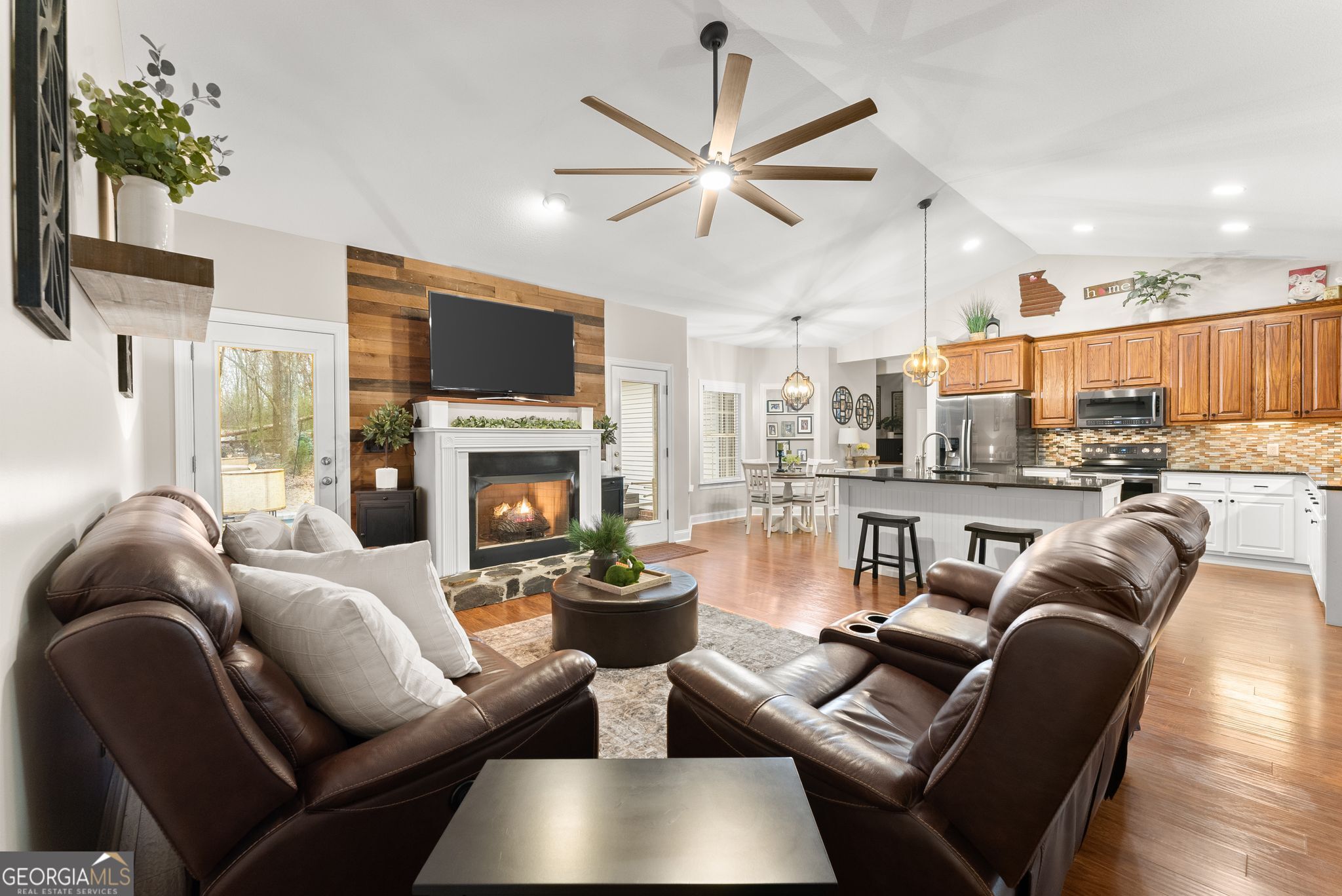 96 Magnolia Place Commerce, GA 30529 - Photo 12 of 58 a living room with furniture a flat screen tv and a fireplace
