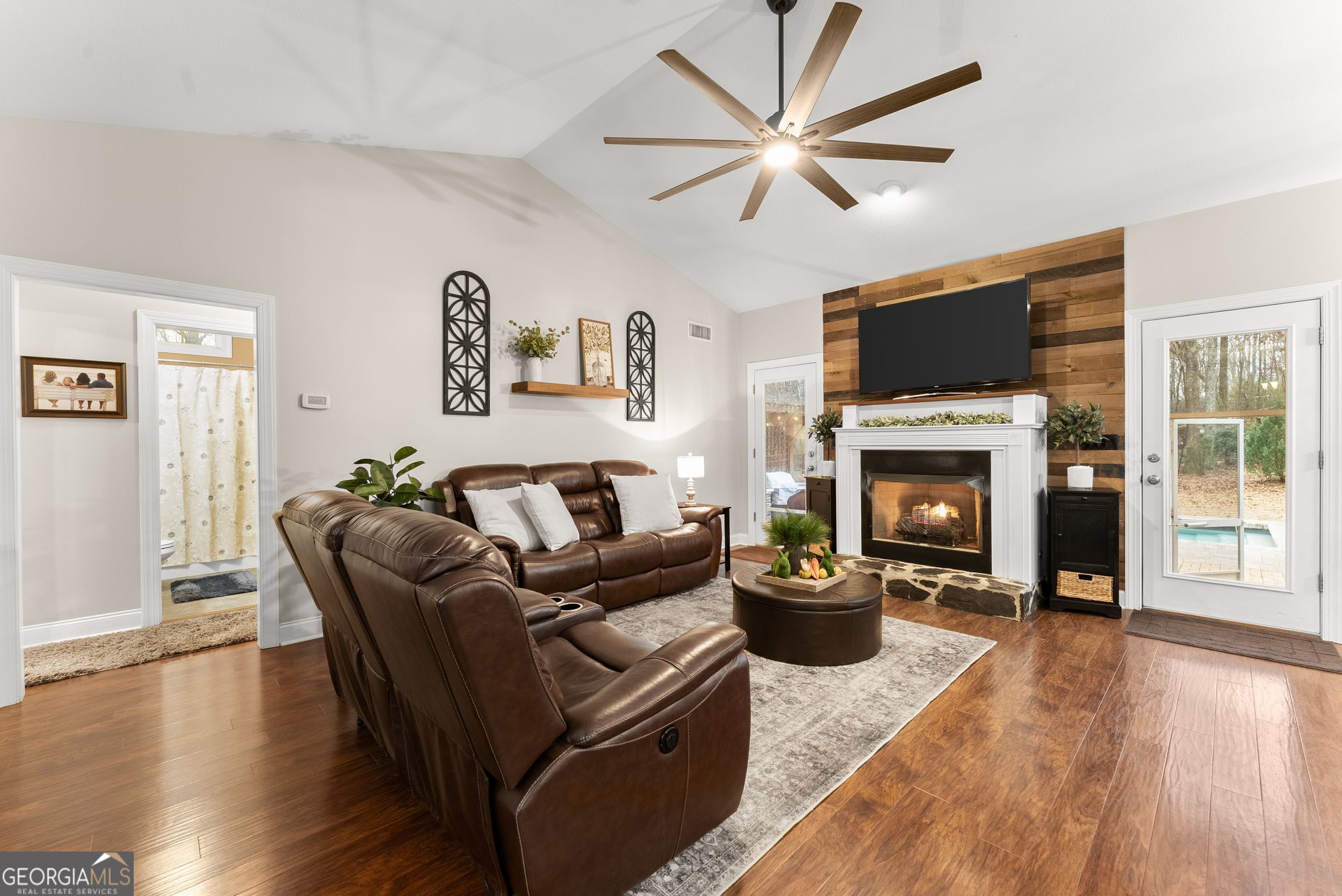 96 Magnolia Place Commerce, GA 30529 - Photo 13 of 58 a living room with furniture a fireplace and a flat screen tv