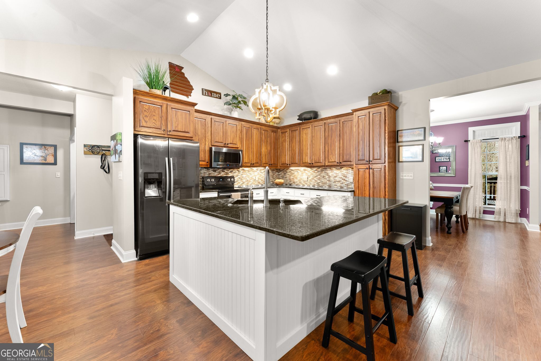 96 Magnolia Place Commerce, GA 30529 - Photo 15 of 58 a kitchen with granite countertop a refrigerator a stove a dining table and chairs with wooden floor