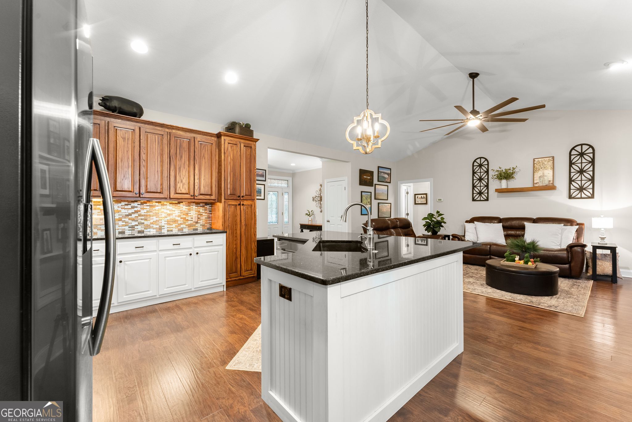 96 Magnolia Place Commerce, GA 30529 - Photo 17 of 58 a kitchen with stainless steel appliances granite countertop a refrigerator a stove a sink and a dining table with wooden floor