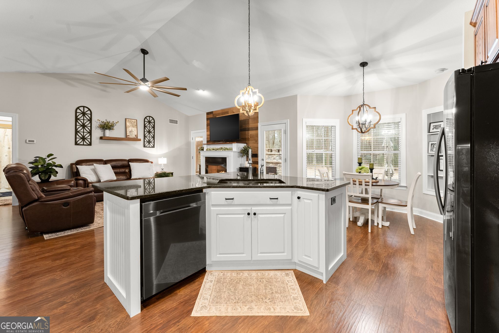 96 Magnolia Place Commerce, GA 30529 - Photo 18 of 58 a kitchen with stainless steel appliances granite countertop a refrigerator a sink dishwasher a dining table and chairs with wooden floor