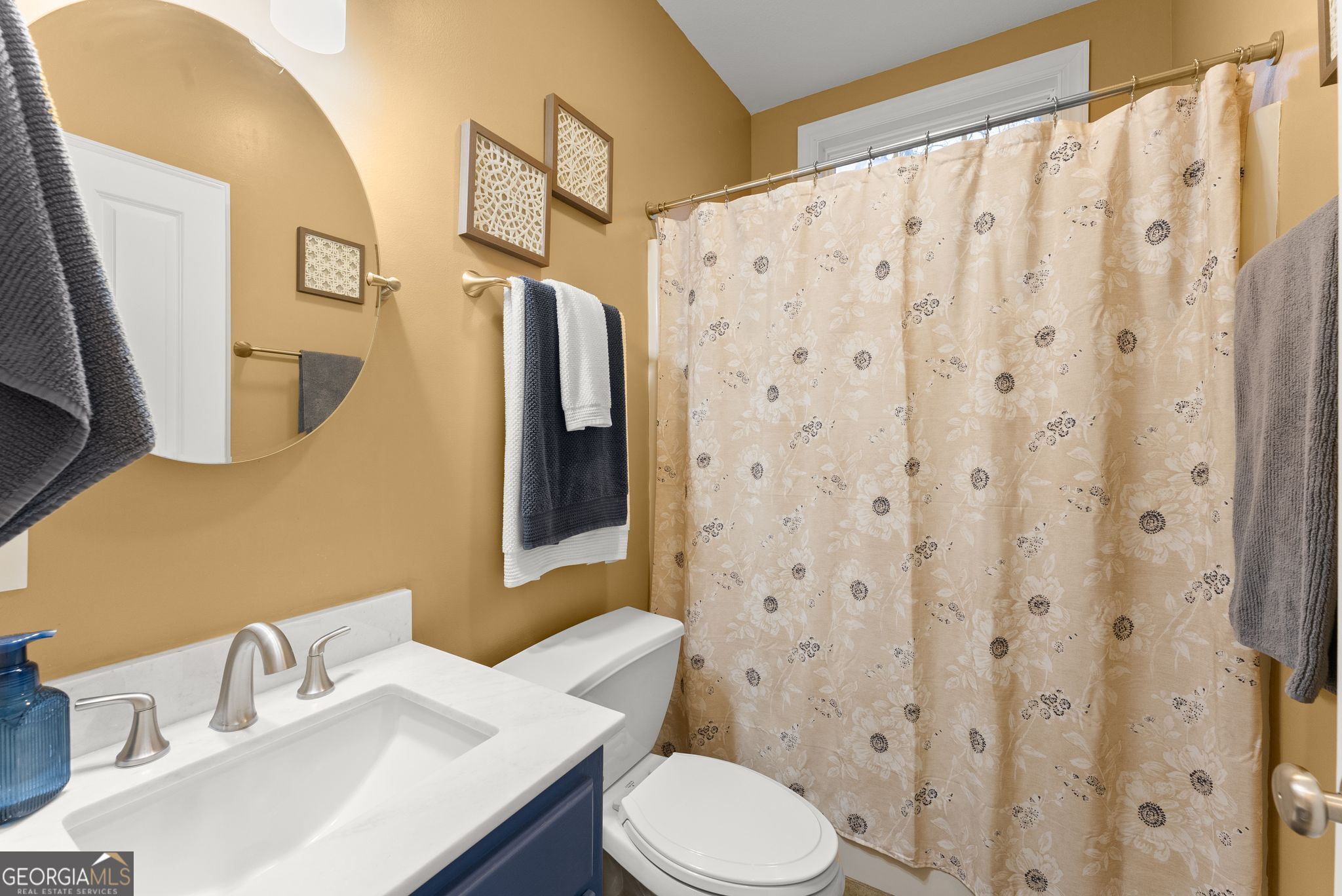 96 Magnolia Place Commerce, GA 30529 - Photo 27 of 58 a bathroom with a sink a toilet and shower curtain