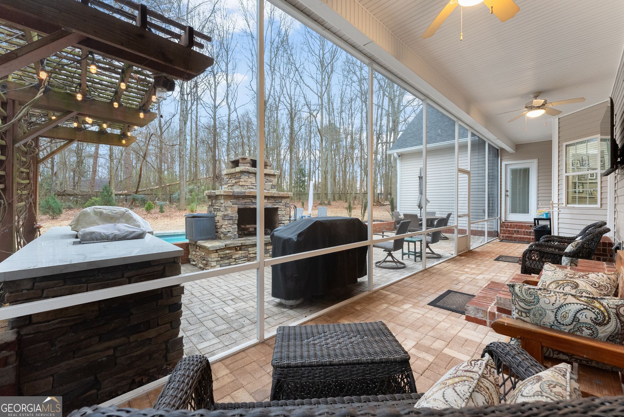 96 Magnolia Place Commerce, GA 30529 - Photo 33 of 58 a living room with furniture a rug and a fireplace