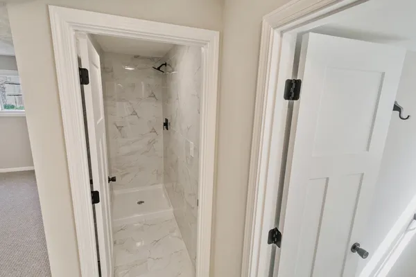 a bathroom with a glass shower door and a sink