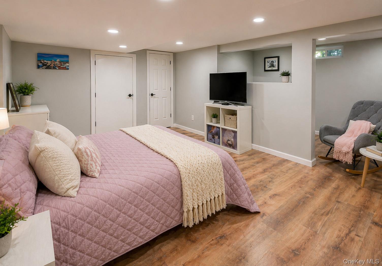 6 Huyler Road Setauket, NY 11733 - Photo 13 of 27 a bedroom with a bed and a flat screen tv