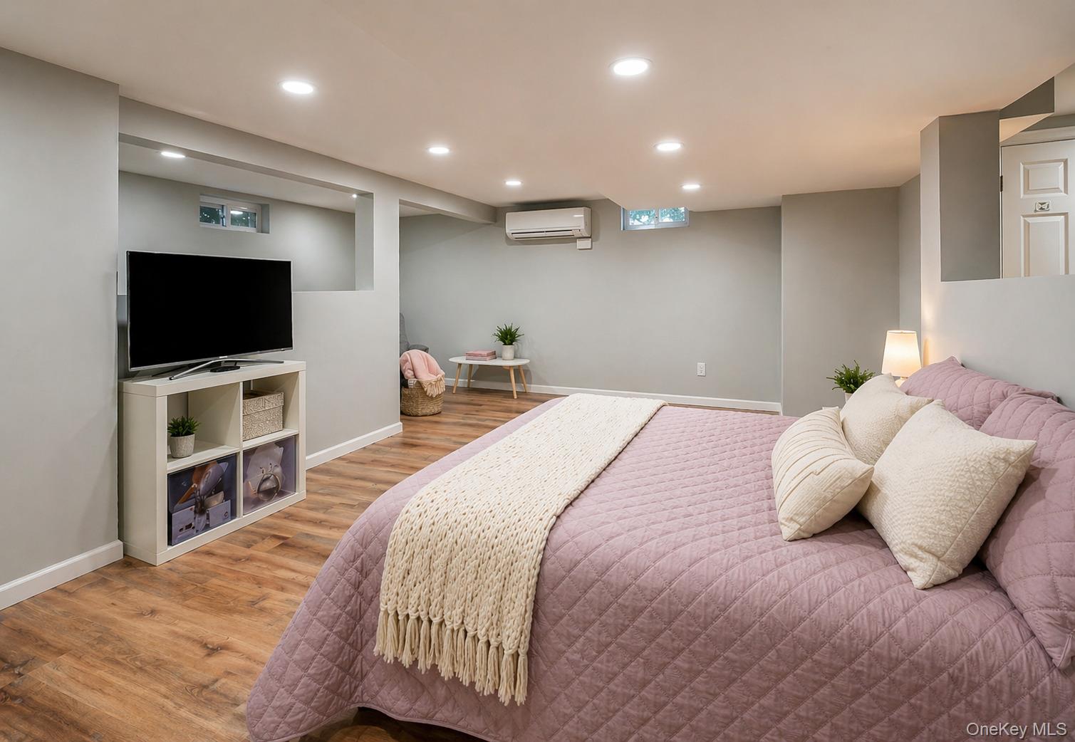 6 Huyler Road Setauket, NY 11733 - Photo 14 of 27 a bedroom with a bed and a flat screen tv