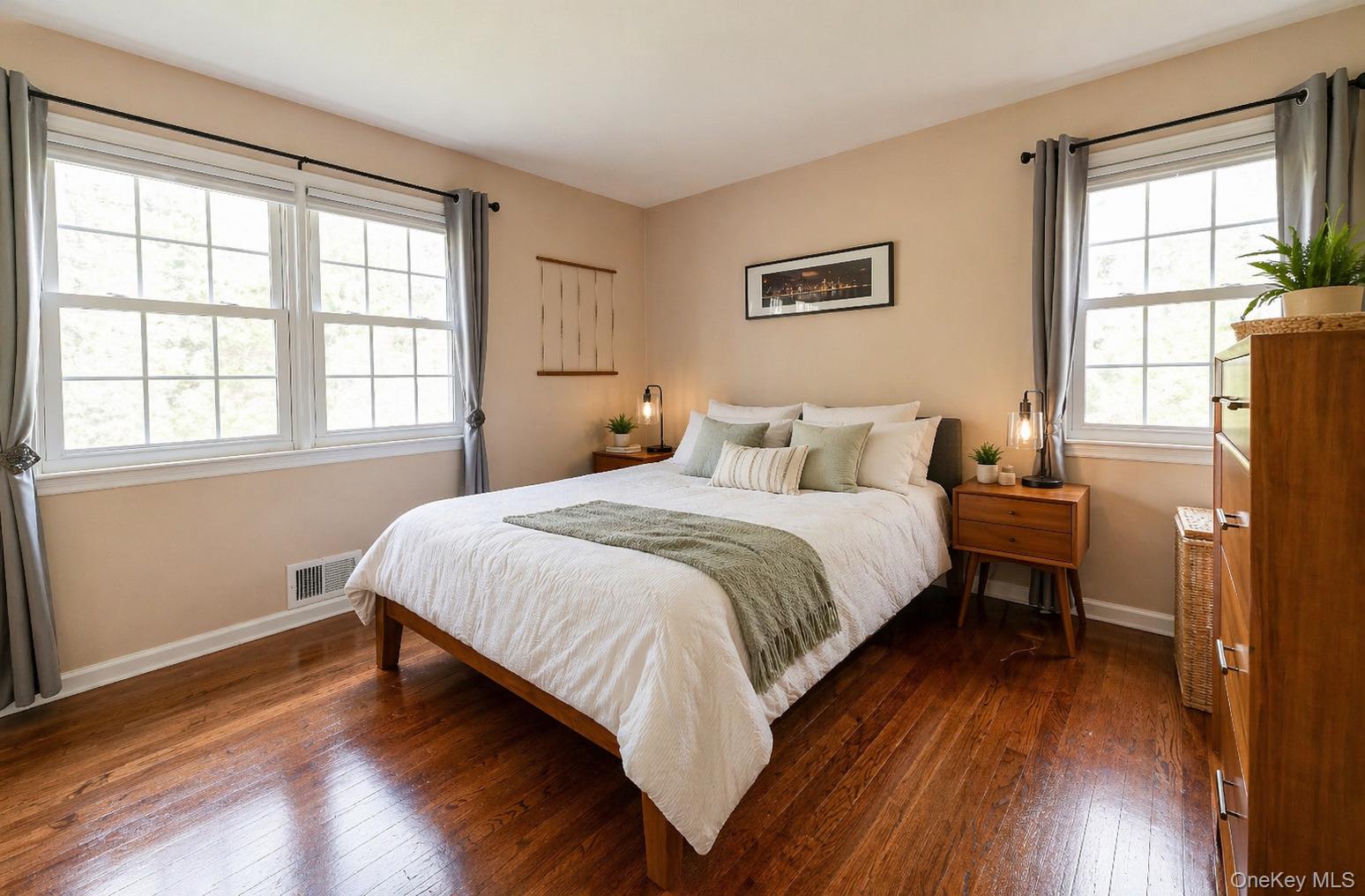 6 Huyler Road Setauket, NY 11733 - Photo 15 of 27 a bedroom with a bed and wooden floor