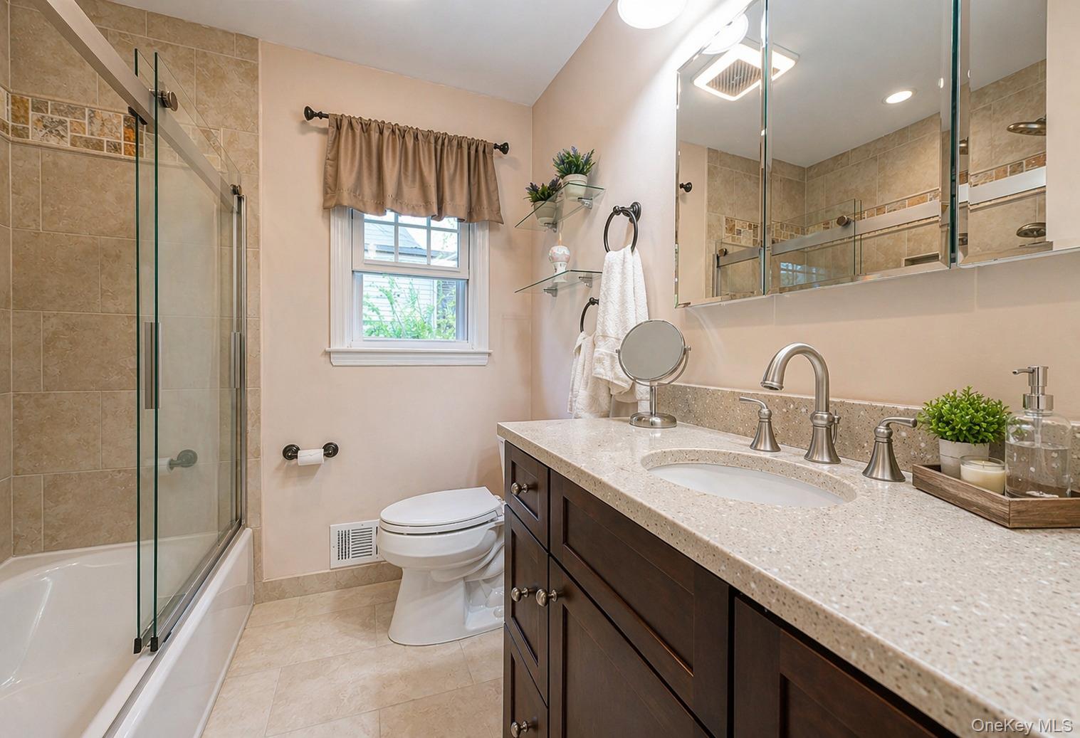 6 Huyler Road Setauket, NY 11733 - Photo 20 of 27 a bathroom with a granite countertop sink a toilet and shower