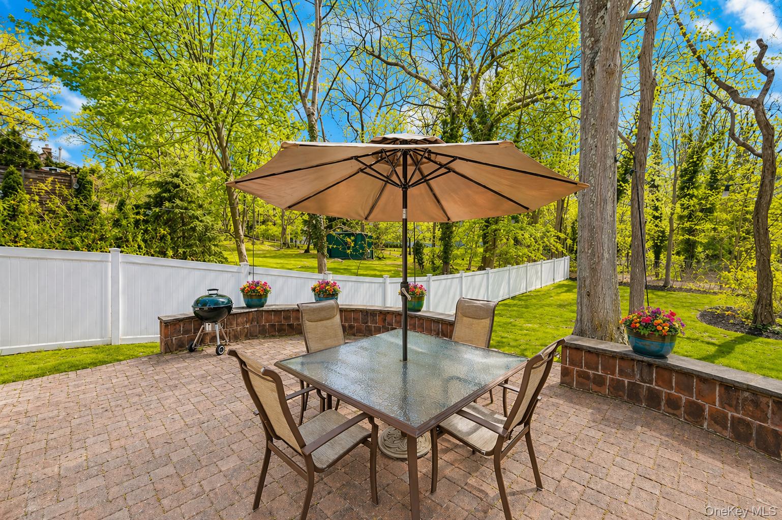 6 Huyler Road Setauket, NY 11733 - Photo 23 of 27 an outdoor space with furniture and umbrella
