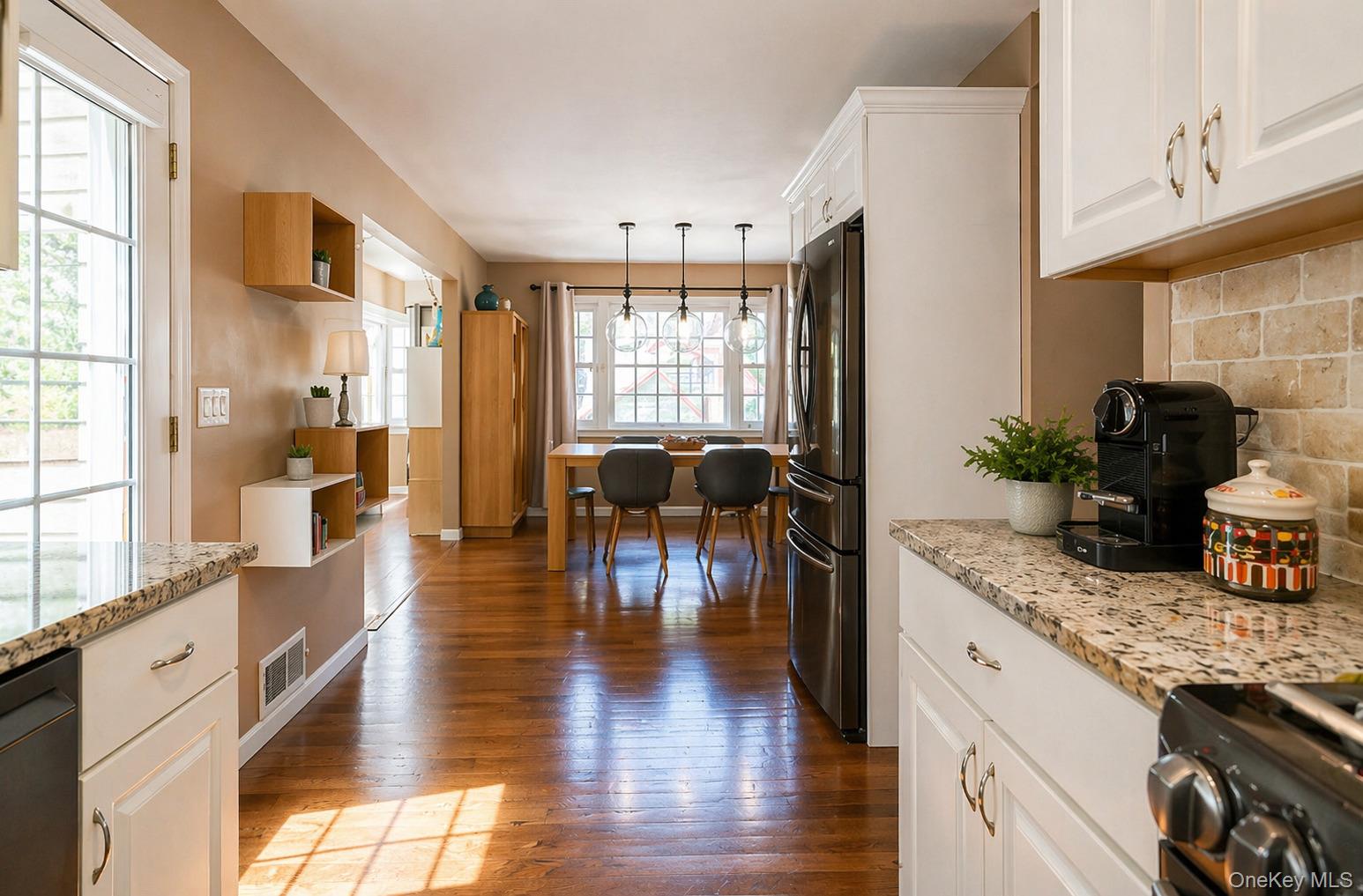 6 Huyler Road Setauket, NY 11733 - Photo 6 of 27 a view of a kitchen with kitchen island granite countertop wooden floor and stainless steel appliances