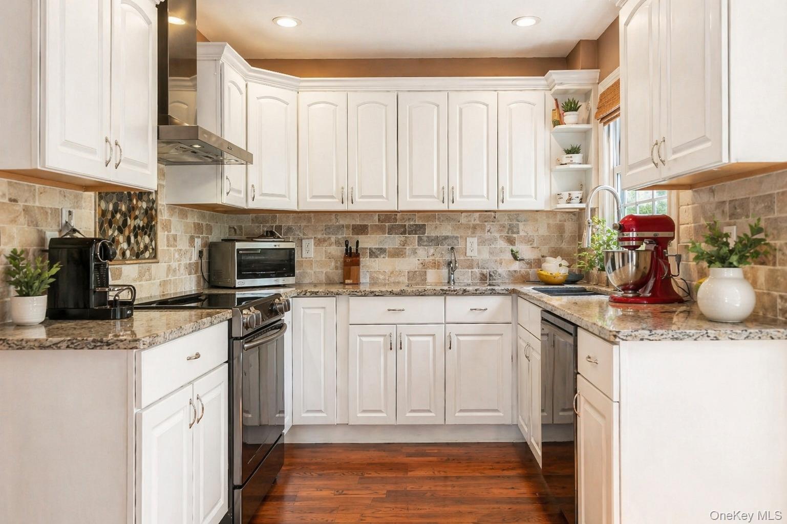 6 Huyler Road Setauket, NY 11733 - Photo 7 of 27 a kitchen with stainless steel appliances granite countertop a sink a stove and cabinets