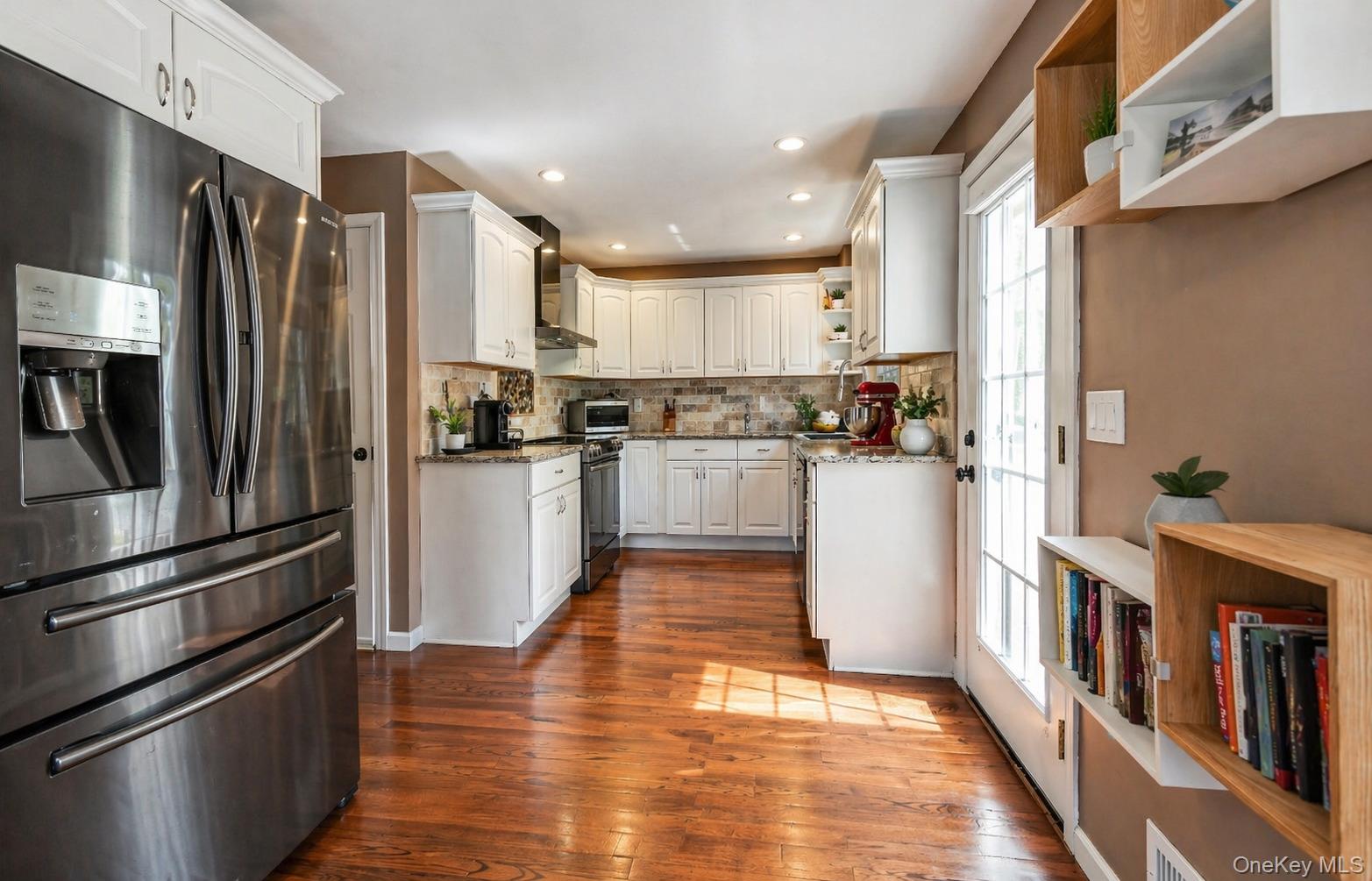 6 Huyler Road Setauket, NY 11733 - Photo 8 of 27 a kitchen with stainless steel appliances granite countertop a refrigerator a stove a sink and a refrigerator