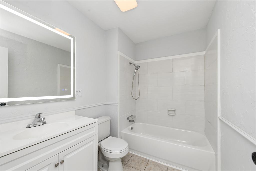 2119 Meadfoot Road Carrollton, TX 75007 - Photo 22 of 30 Full bath featuring vanity, bathing tub / shower combination, and light tile patterned flooring