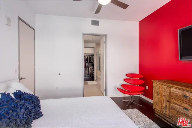 a bedroom with a bed and a potted plant