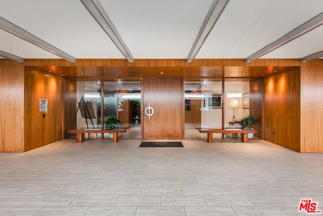 a view of a room with table and chairs