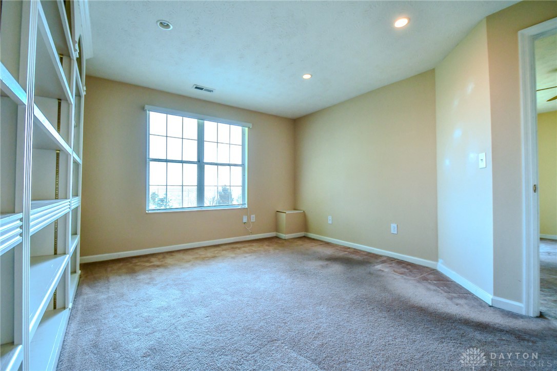 3915 East Summit Ridge Drive Beavercreek, OH 45430 - Photo 39 of 47 This versatile space features built-in shelving, plush carpeting, and abundant natural light.