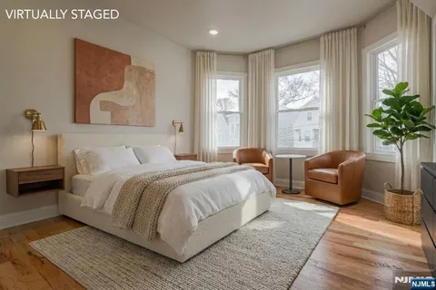 a bedroom with a large bed couch and a window