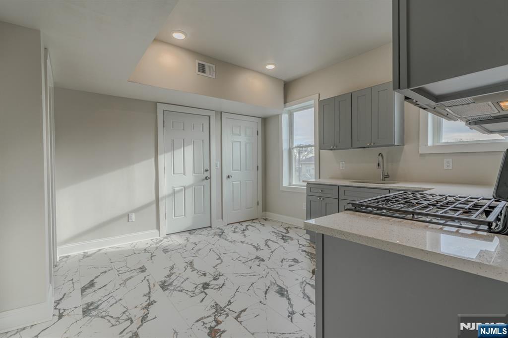 882 South 14th Street, Unit 2 Newark, NJ 07108 - Photo 11 of 18 a kitchen with a stove a refrigerator and a stove