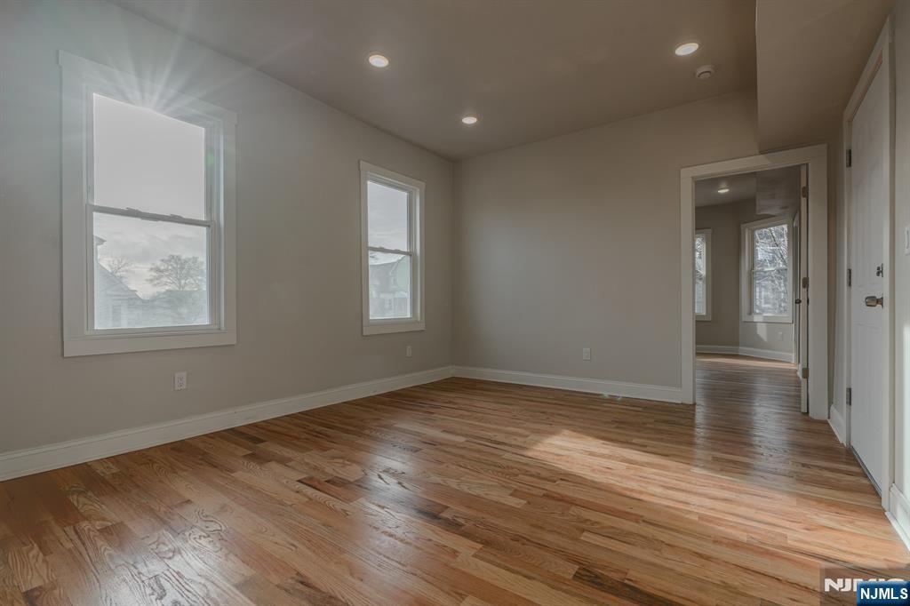 882 South 14th Street, Unit 2 Newark, NJ 07108 - Photo 15 of 18 a view of an empty room with wooden floor and a window