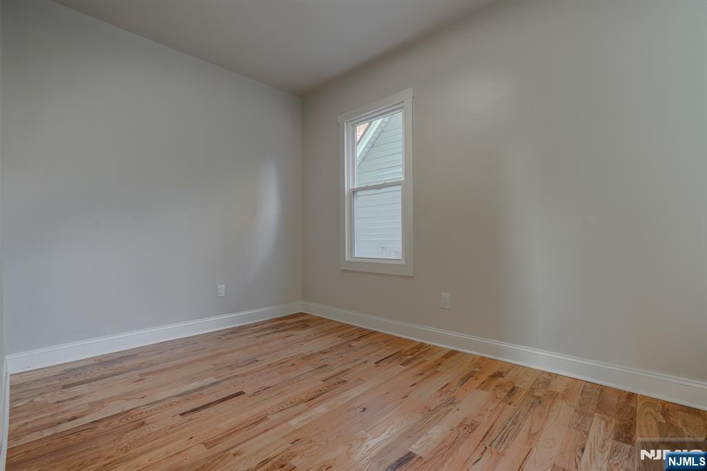 882 South 14th Street, Unit 2 Newark, NJ 07108 - Photo 16 of 18 an empty room with wooden floor and windows