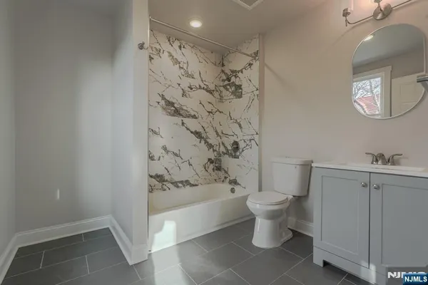 a bathroom with a toilet and a shower curtain