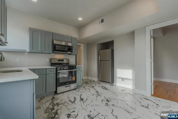 a kitchen with a refrigerator stove and sink