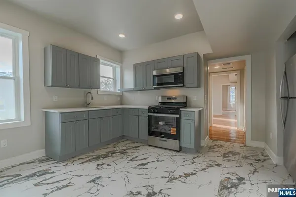 a kitchen with a refrigerator stove and sink