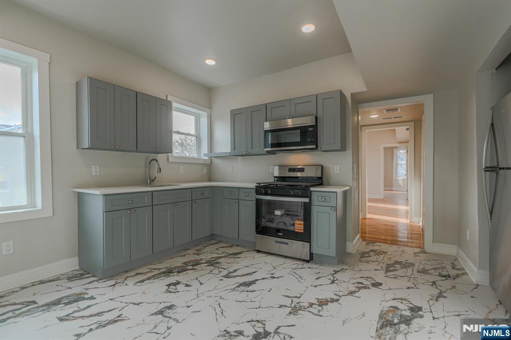 882 South 14th Street, Unit 2 Newark, NJ 07108 - Photo 10 of 18 a kitchen with a refrigerator stove and sink