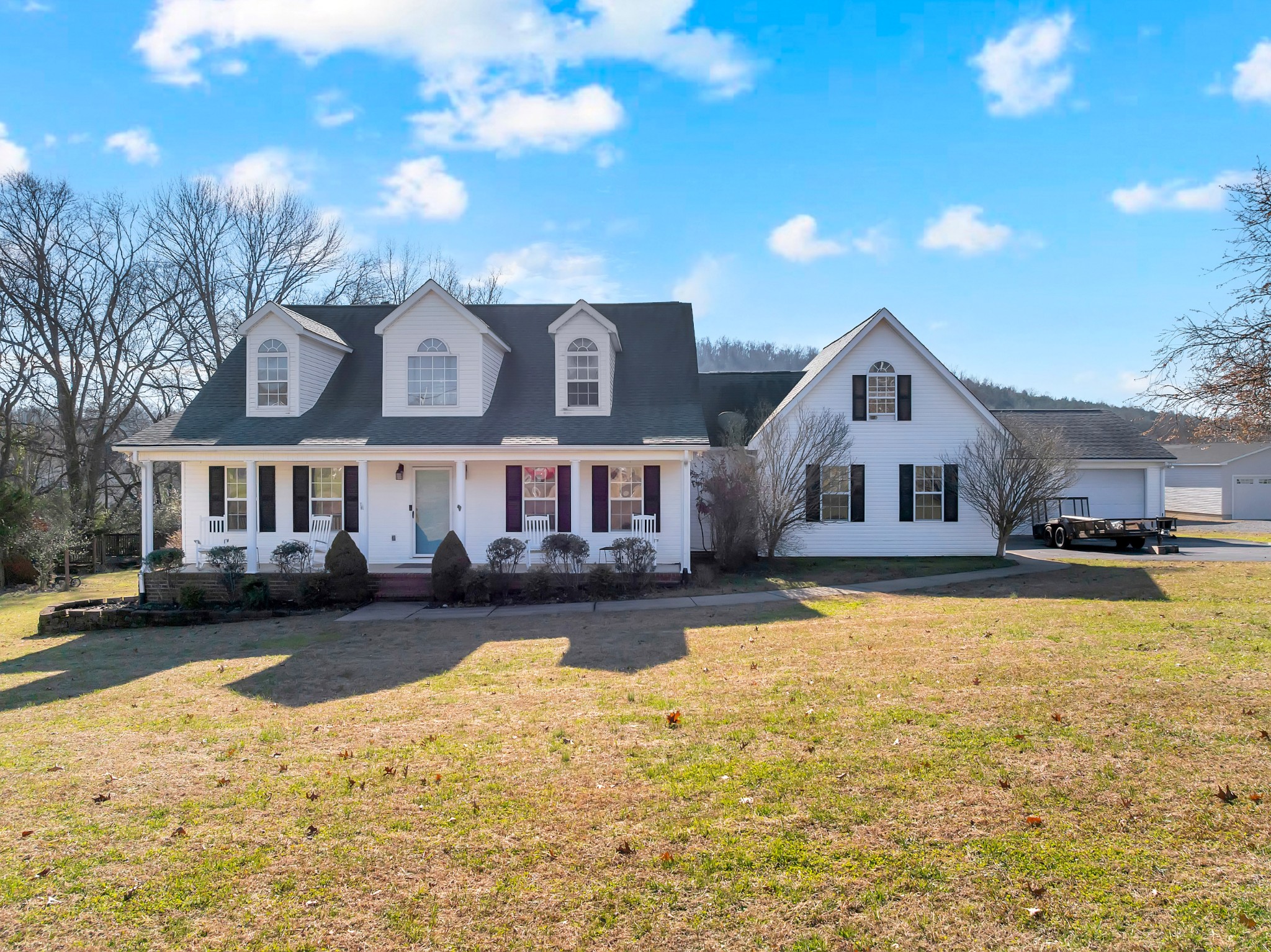 a front view of a house with yard and swimming pool