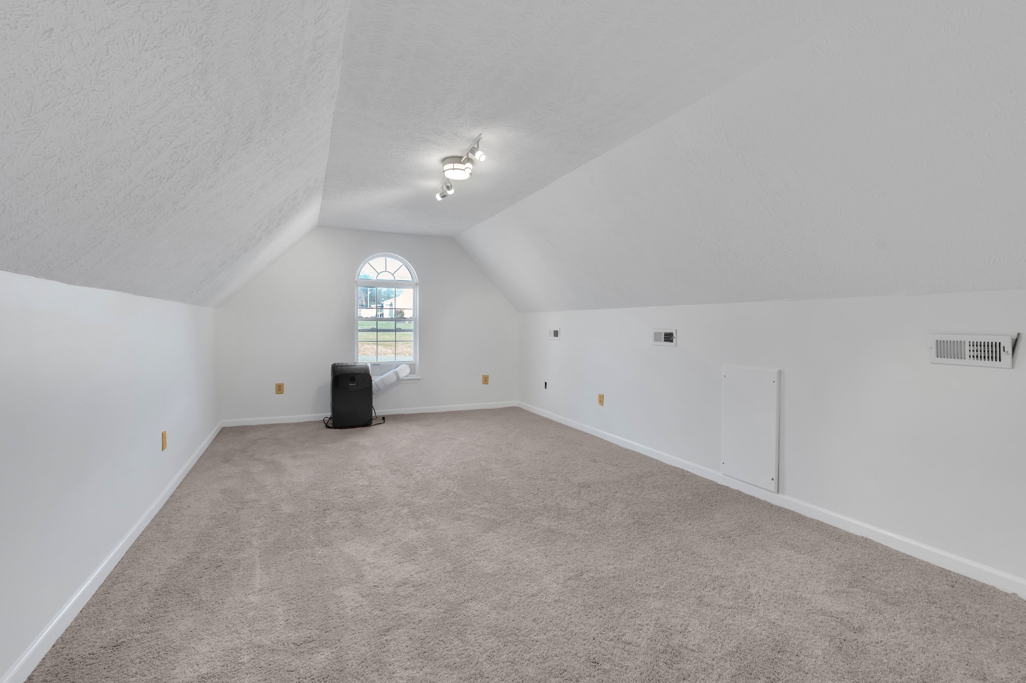 113 Matt Drive Bell Buckle, TN 37020 - Photo 18 of 34 an empty room with chandelier fan and windows