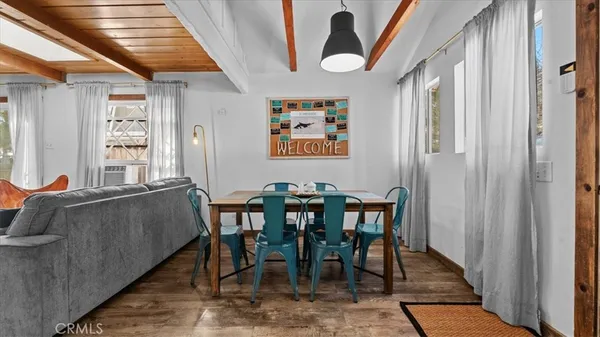 a dining room with furniture and wooden floor