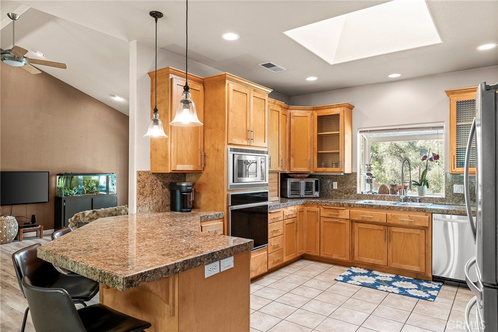 2262 Honey Run Road Chico, CA 95928 - Photo 6 of 74 a kitchen with stainless steel appliances granite countertop a sink counter space and a table