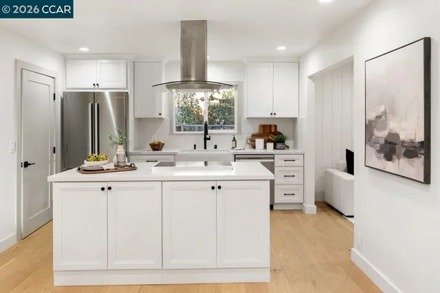 a kitchen with stainless steel appliances a sink stove and refrigerator
