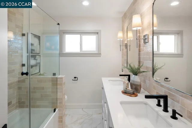a bathroom with a tub sink and mirror