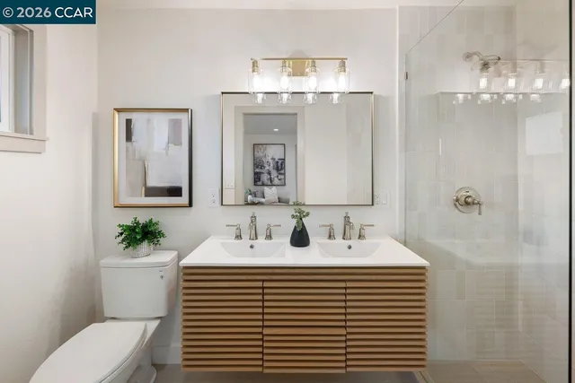 a bathroom with a sink a toilet and mirror