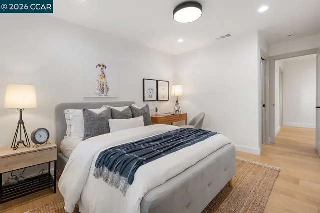 a bedroom with a bed and a lamp