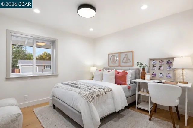 a bedroom with a bed and a table