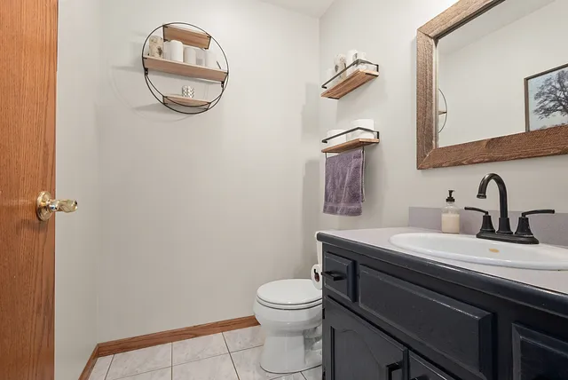 a bathroom with a toilet a sink and mirror