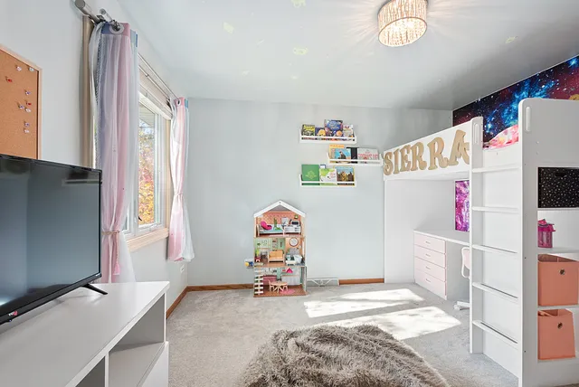 a utility room with fridge and window