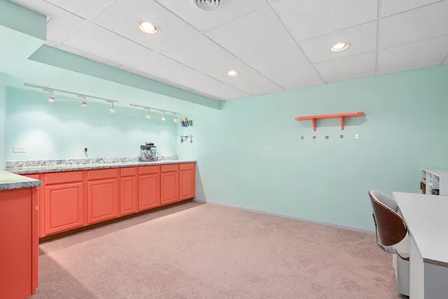 a bathroom with a toilet a sink a mirror a vanity and shower