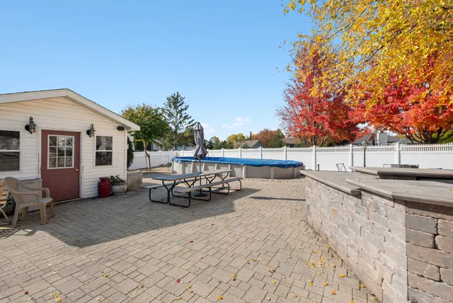 a backyard of a house with table and chairs