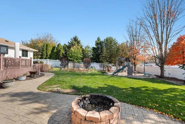 a view of a house with backyard and sitting area
