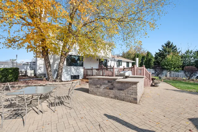 a view of a house with backyard and sitting area