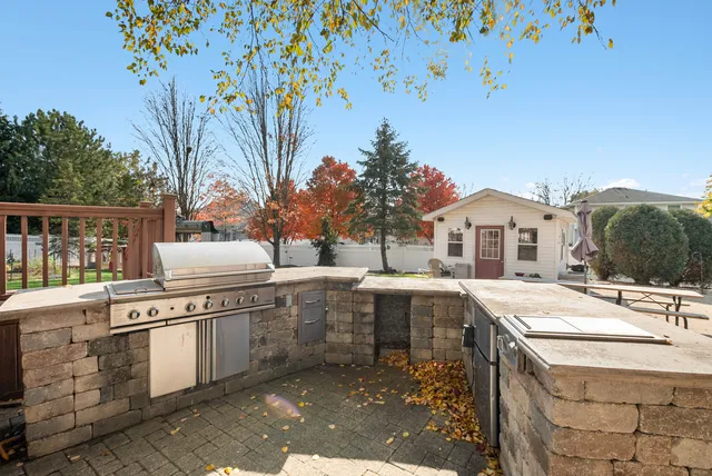 a view of a house with backyard and sitting area