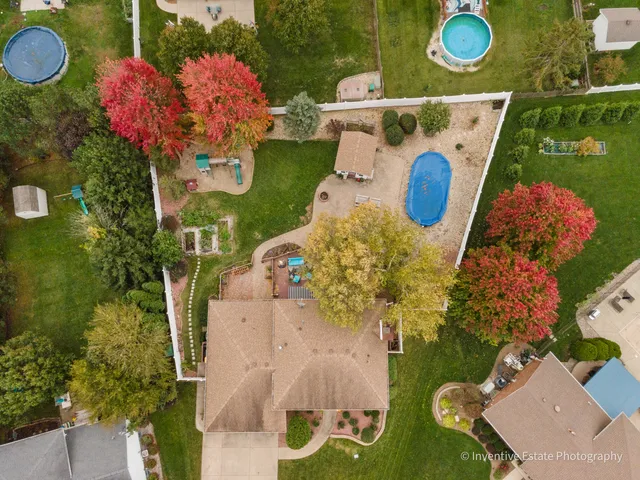 an aerial view of a house with a swimming pool yard and outdoor seating