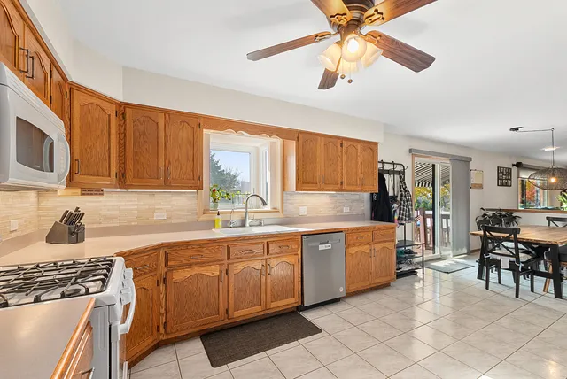 a kitchen with stainless steel appliances granite countertop a sink and cabinets
