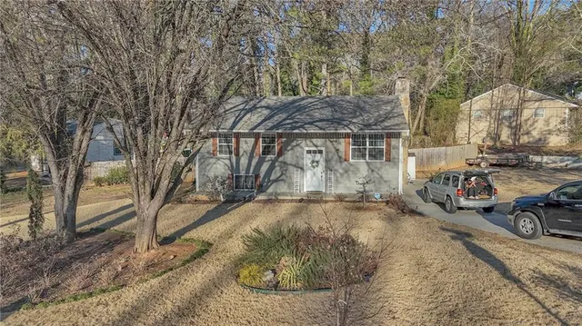 a view of a house with snow on the road