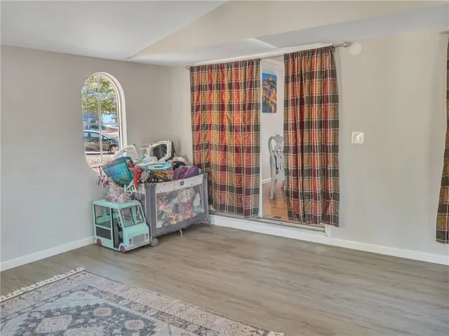 a bathroom with a granite countertop sink a toilet and a mirror