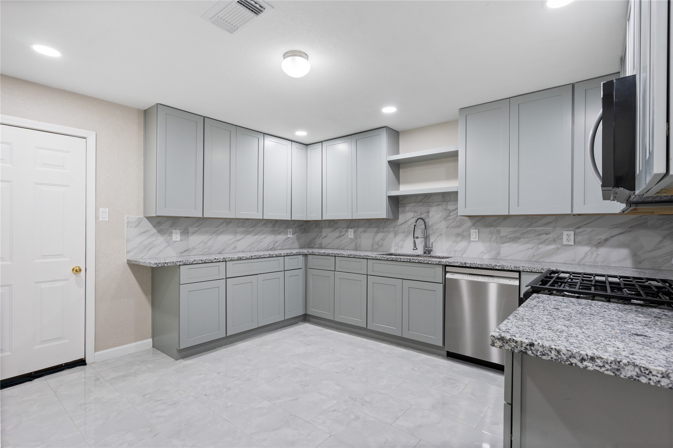 10613 Chadwick Street Houston, TX 77029 - Photo 13 of 30 a kitchen with granite countertop cabinets stainless steel appliances and a sink